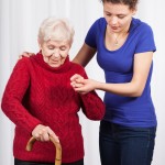 Nurse helping elderly lady walk